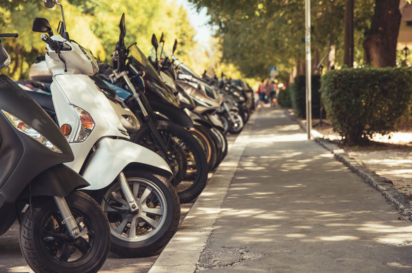 Row of scooters parked in the open area